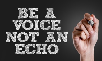 Hand writing the text: Be a Voice Not An Echo